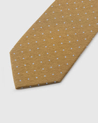 Light blue embroidered pin dot detail on honey gold mulberry silk tie showing raised thread texture by STICKYZOO
