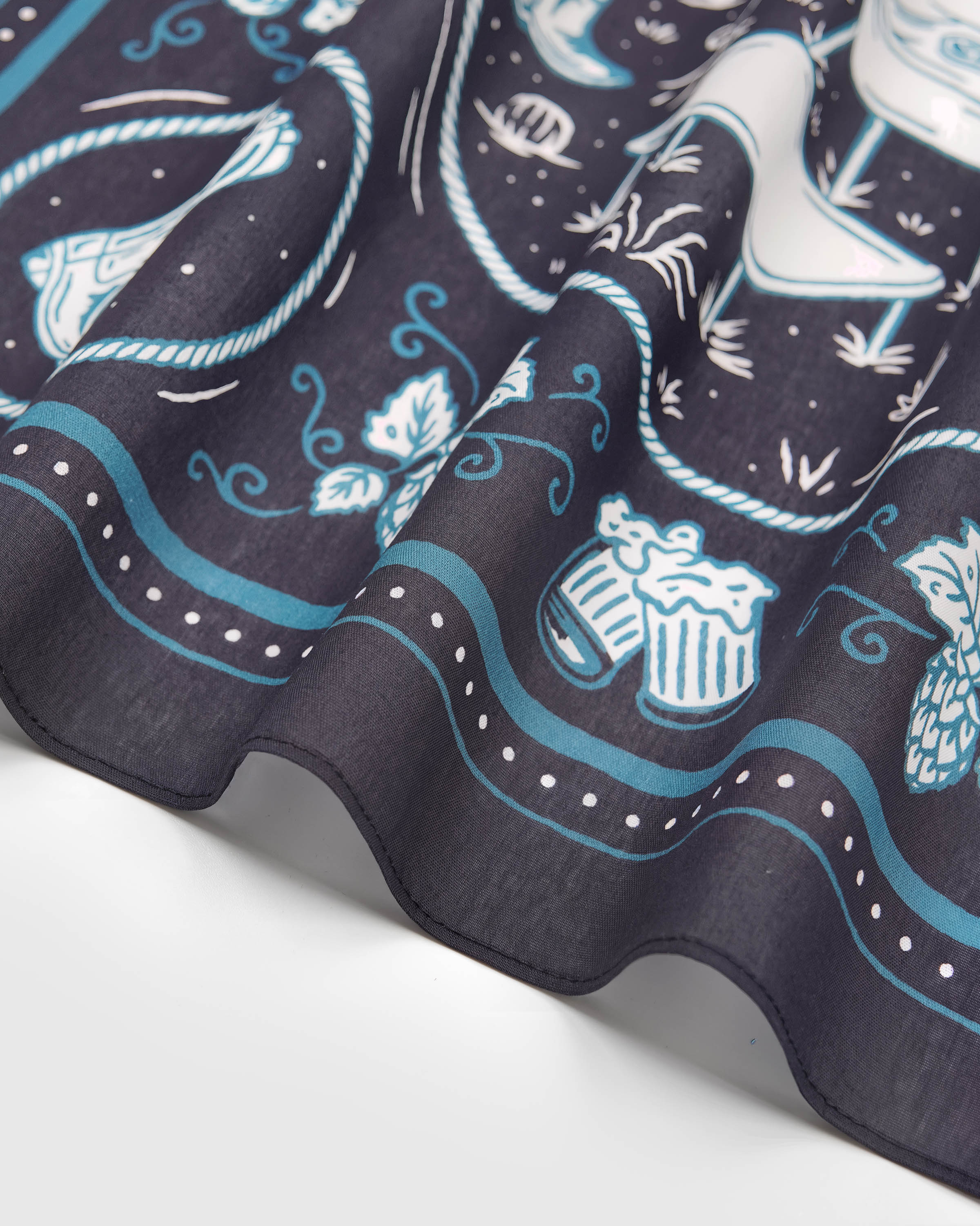 Close-up of the hop-vine border on the campfire critters silk scarf showing the soft drape of pure silk