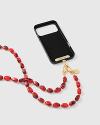 Full phone with ruby smoke strap draped alongside on neutral background