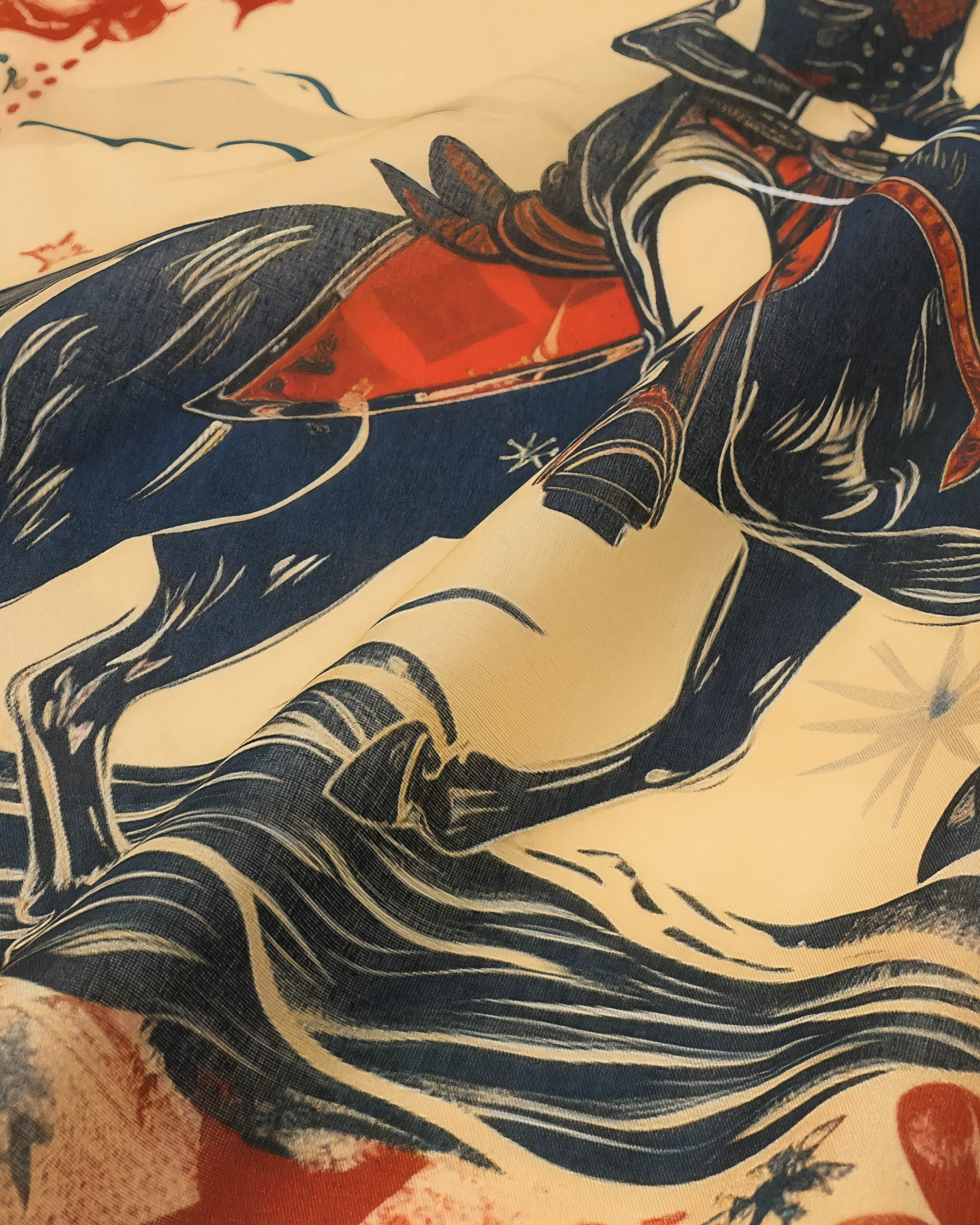 Detail of the hand-illustrated cowgirl on horseback printed in navy and vermilion across the silk
```