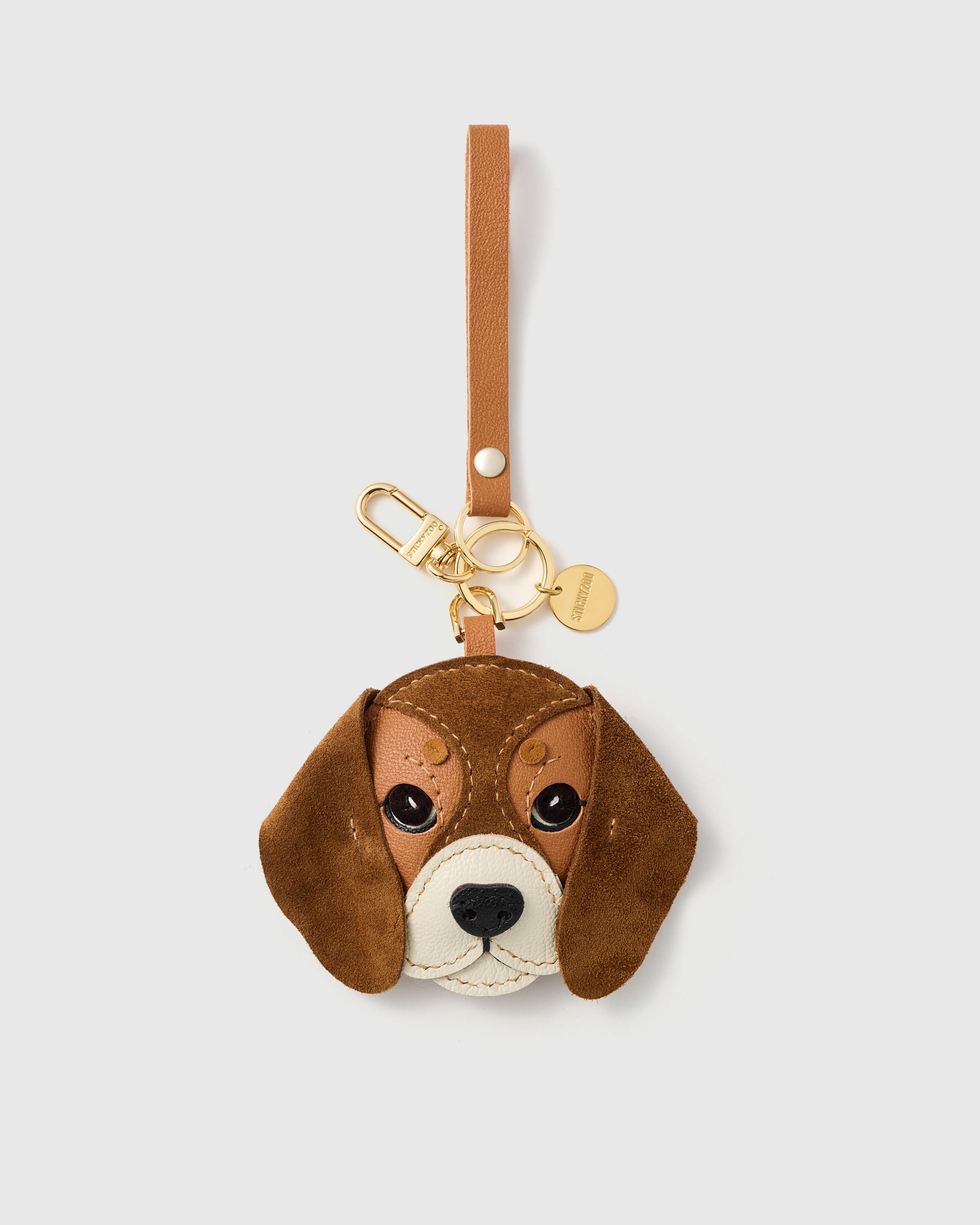 {{Keychain edition.}} beagle charm on 18K gold-plated keychain clip with engraved STICKYZOO disc — French Alran goatskin face, alcantara suede floppy ears, cream leather muzzle. 72 hours by hand.