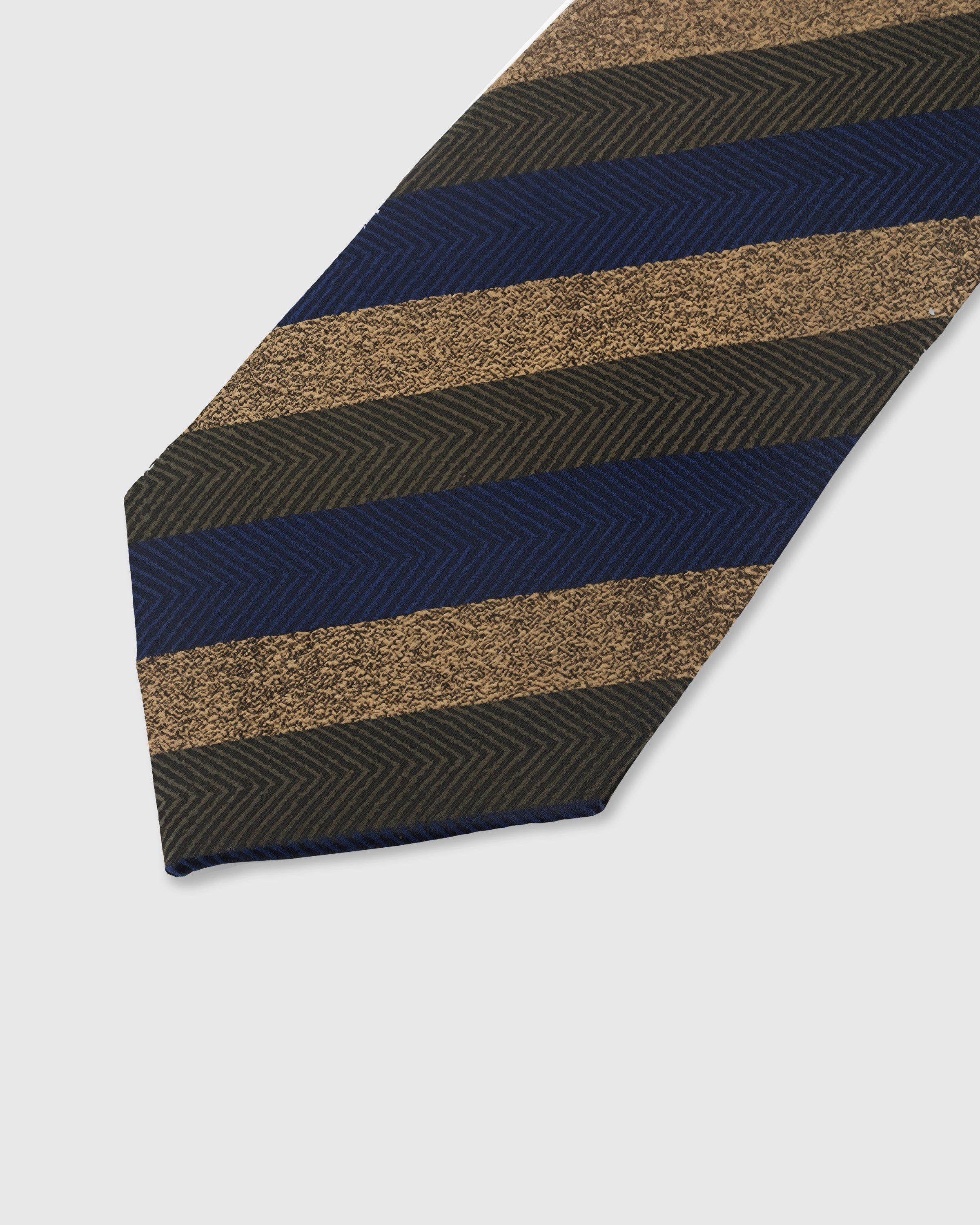 NAVY HERRINGBONE TIE — 45° Italian bias-cut construction with structured interlining, hand-finished slip stitching visible on interior