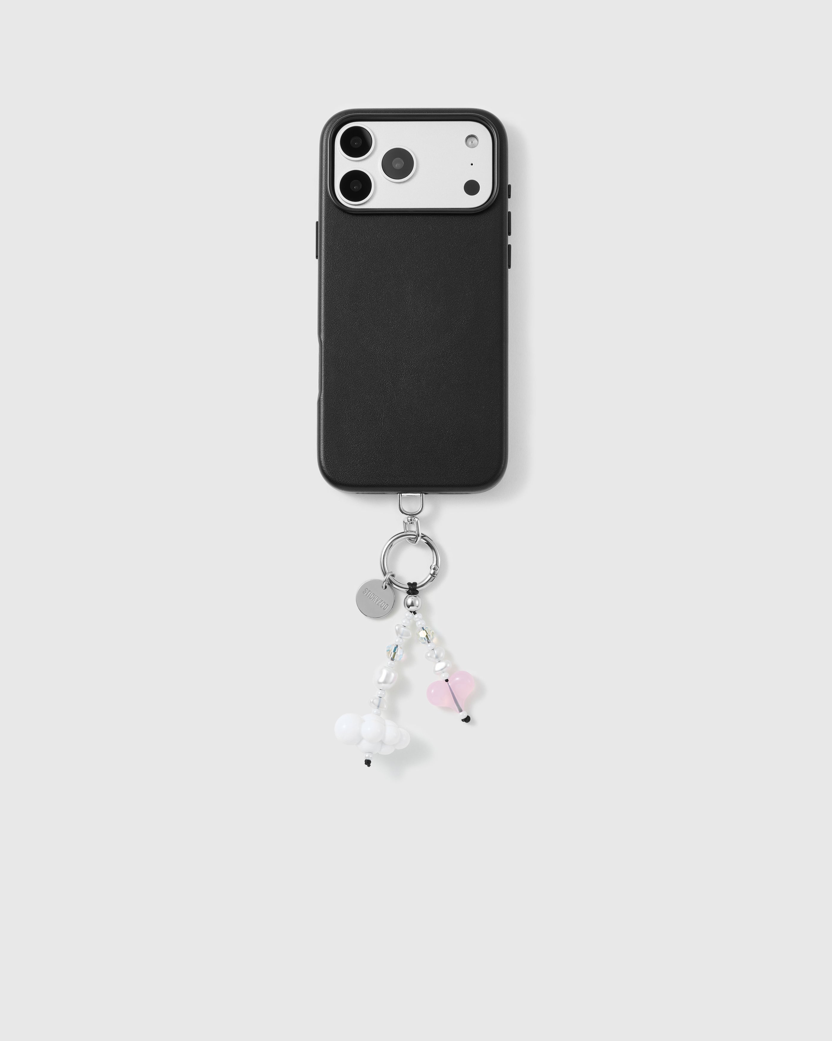 Black phone case with the cloud and pink heart beaded strap dropping from the bottom corner on a silver-tone ring and engraved disc.