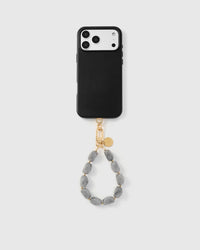 Full phone with grey marble stone strap attached on light background