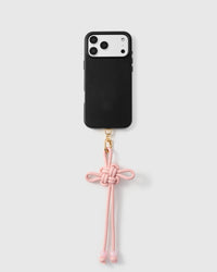 Rose knot phone strap attached to black phone case showing decorative hanging detail