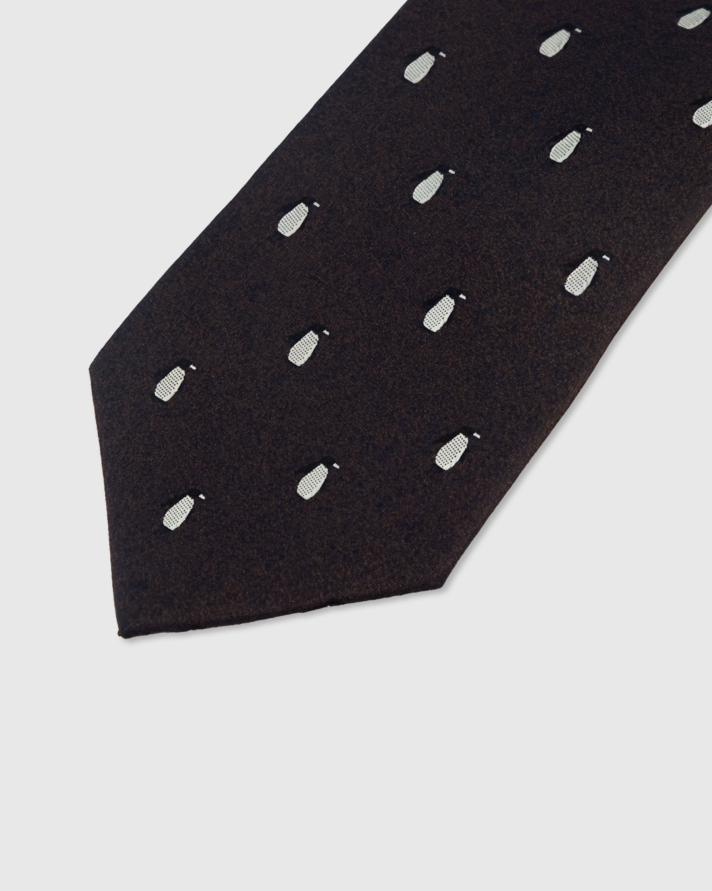 White penguin motif detail on onyx mulberry silk tie showing raised hand-embroidered thread by STICKYZOO