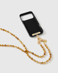 Black MagSafe phone case with a gold-tone STICKYZOO plate and dual clasps holding the amber beaded crossbody strap.