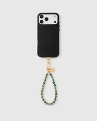 Turquoise stone strap attached to black phone case showing universal compatibility