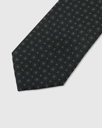 Teal circlet medallion detail on mulberry silk tie showing raised hand-embroidered thread with gold center by STICKYZOO