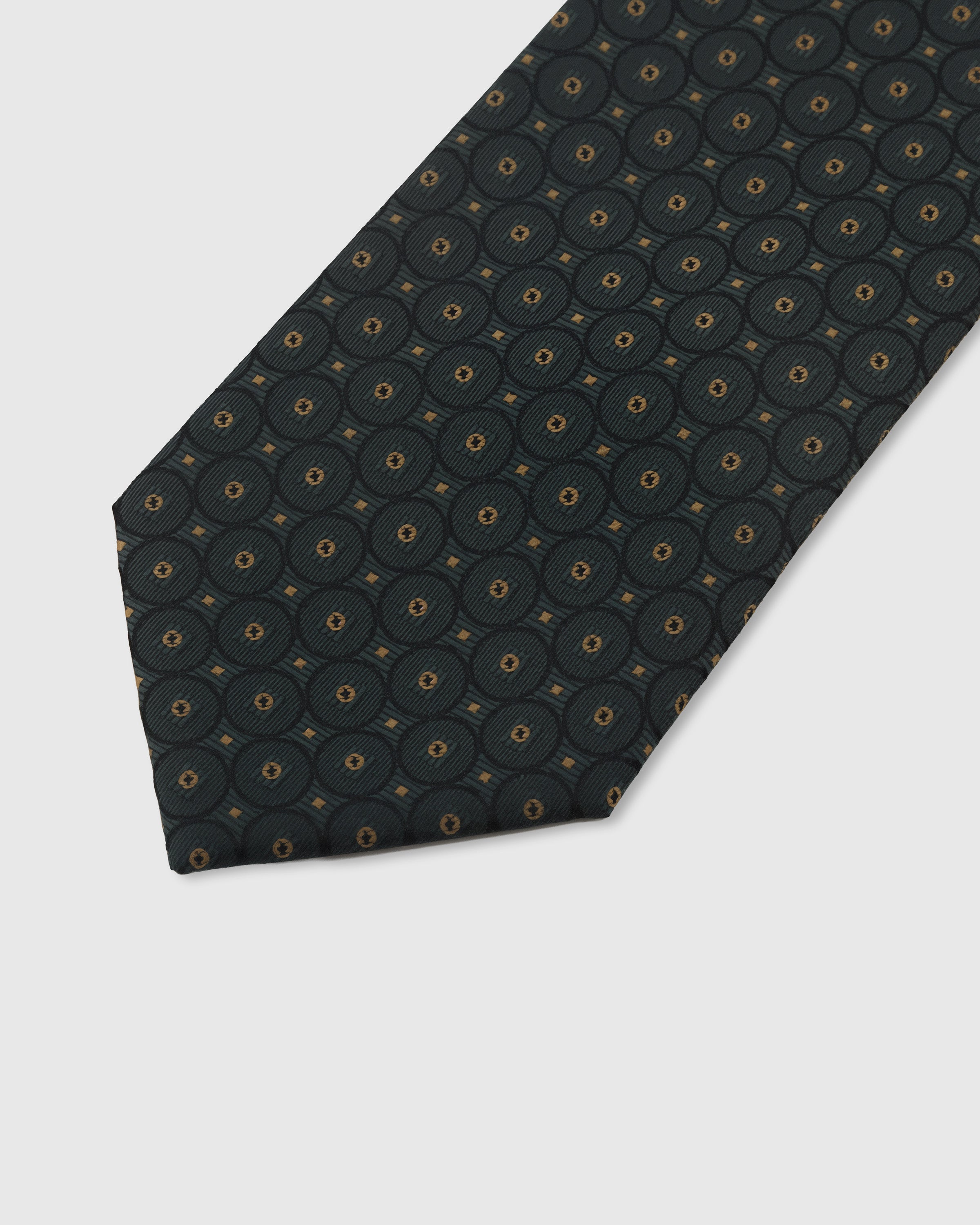Teal circlet medallion detail on mulberry silk tie showing raised hand-embroidered thread with gold center by STICKYZOO