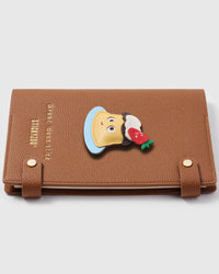 Strawberry pudding charm detail showing hand-cut layers — cream, chocolate, strawberry, blue plate on STICKYZOO A5 notebook