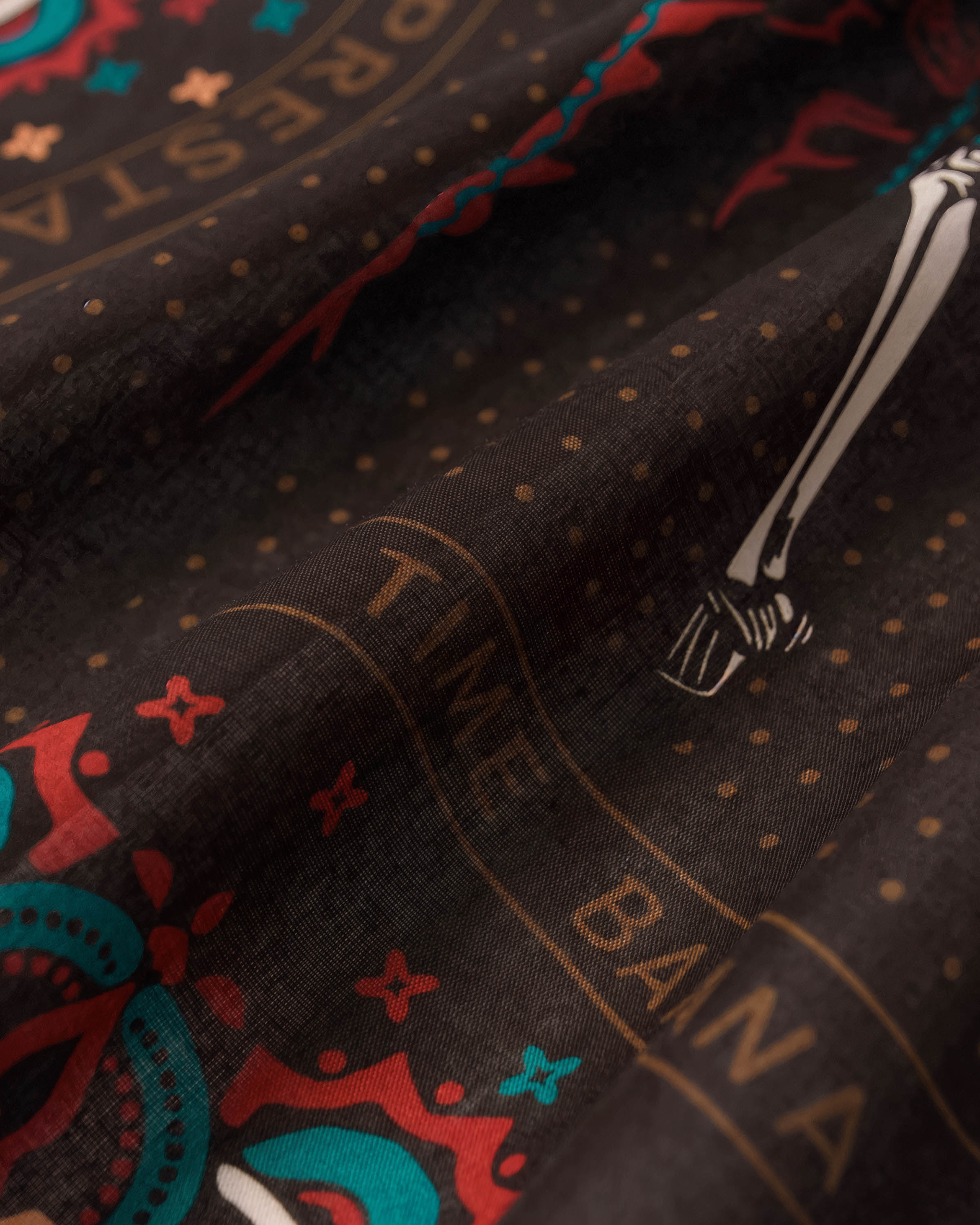 Close-up of the hand-illustrated skeleton dancer in red dress printed on the charcoal silk field
```