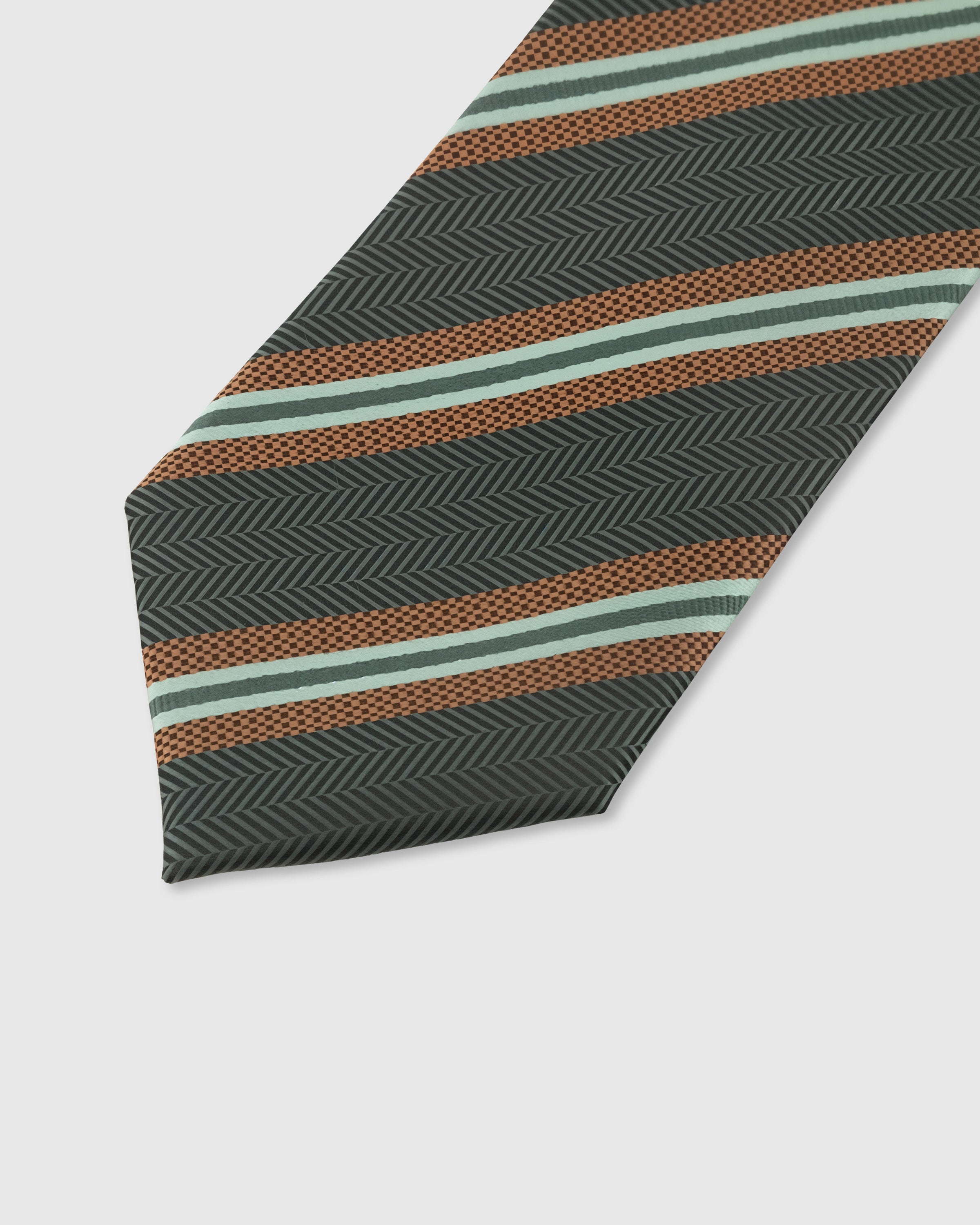GRAPHITE HERRINGBONE TIE — 45° Italian bias-cut construction with structured interlining, hand-finished slip stitching visible on interior