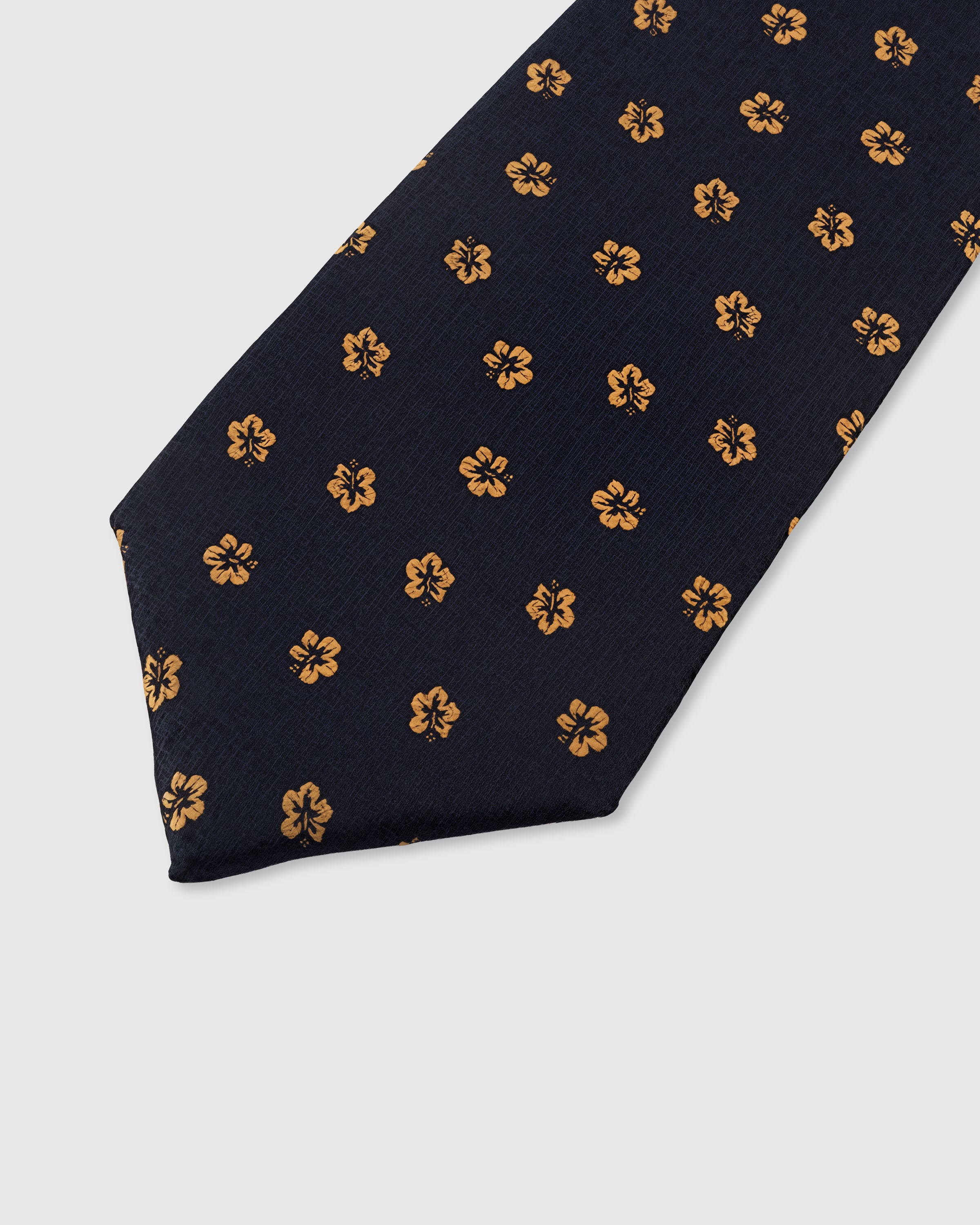 STICKYZOO NAVY HIBISCUS TIE — hand-embroidered detail showing golden amber hibiscus bloom motifs, stitched not printed