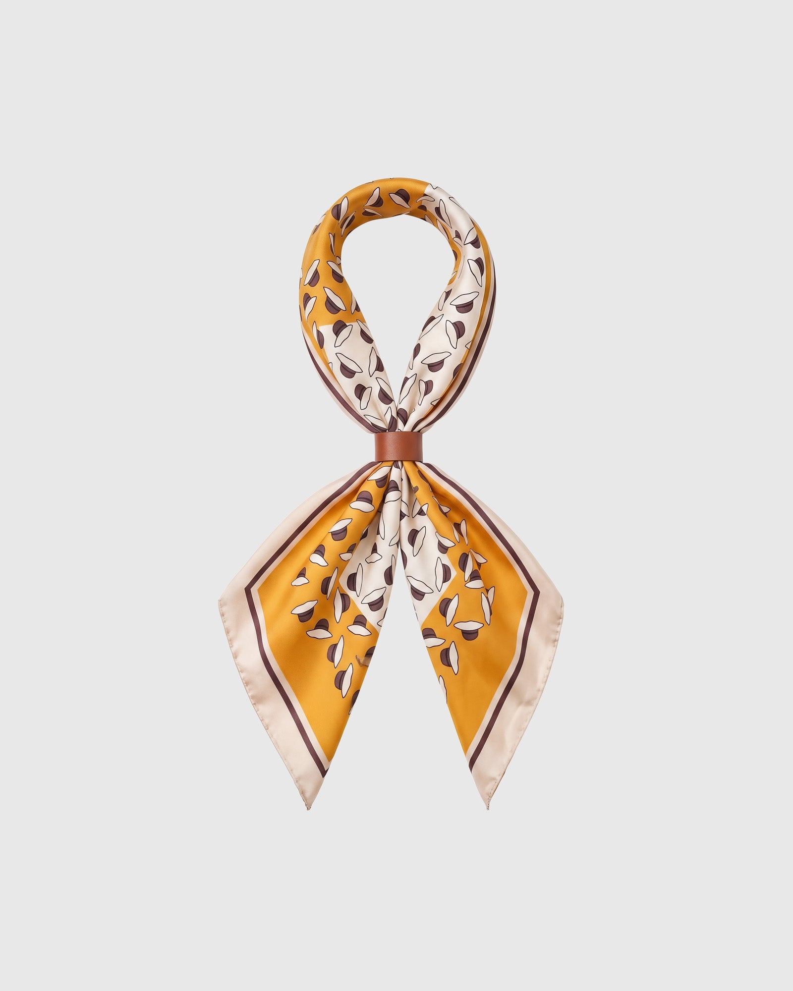 STICKYZOO saffron orchard silk scarf looped through a leather scarf ring showing the petal motif and aubergine pinstripe frame