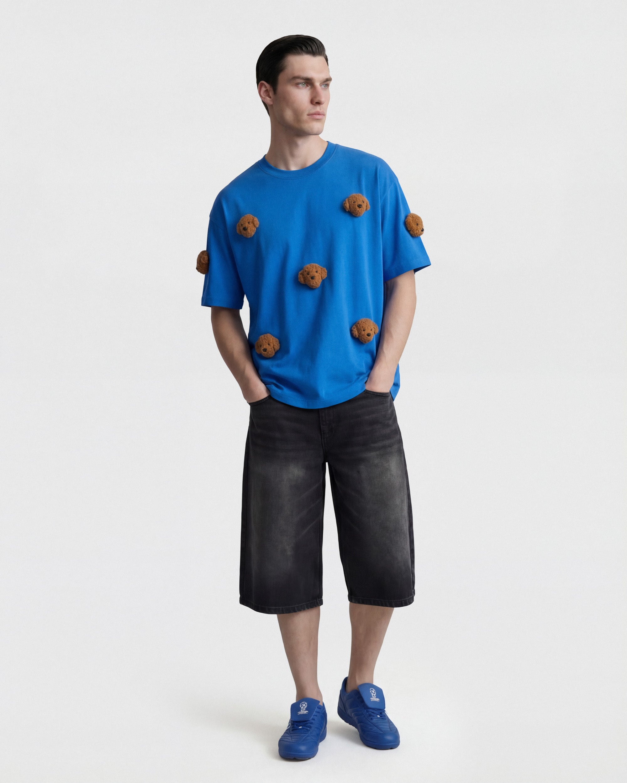 {{Runs true — oversized fit}} Model in blue Poodle Parade T-Shirt with hands in pockets showing relaxed silhouette