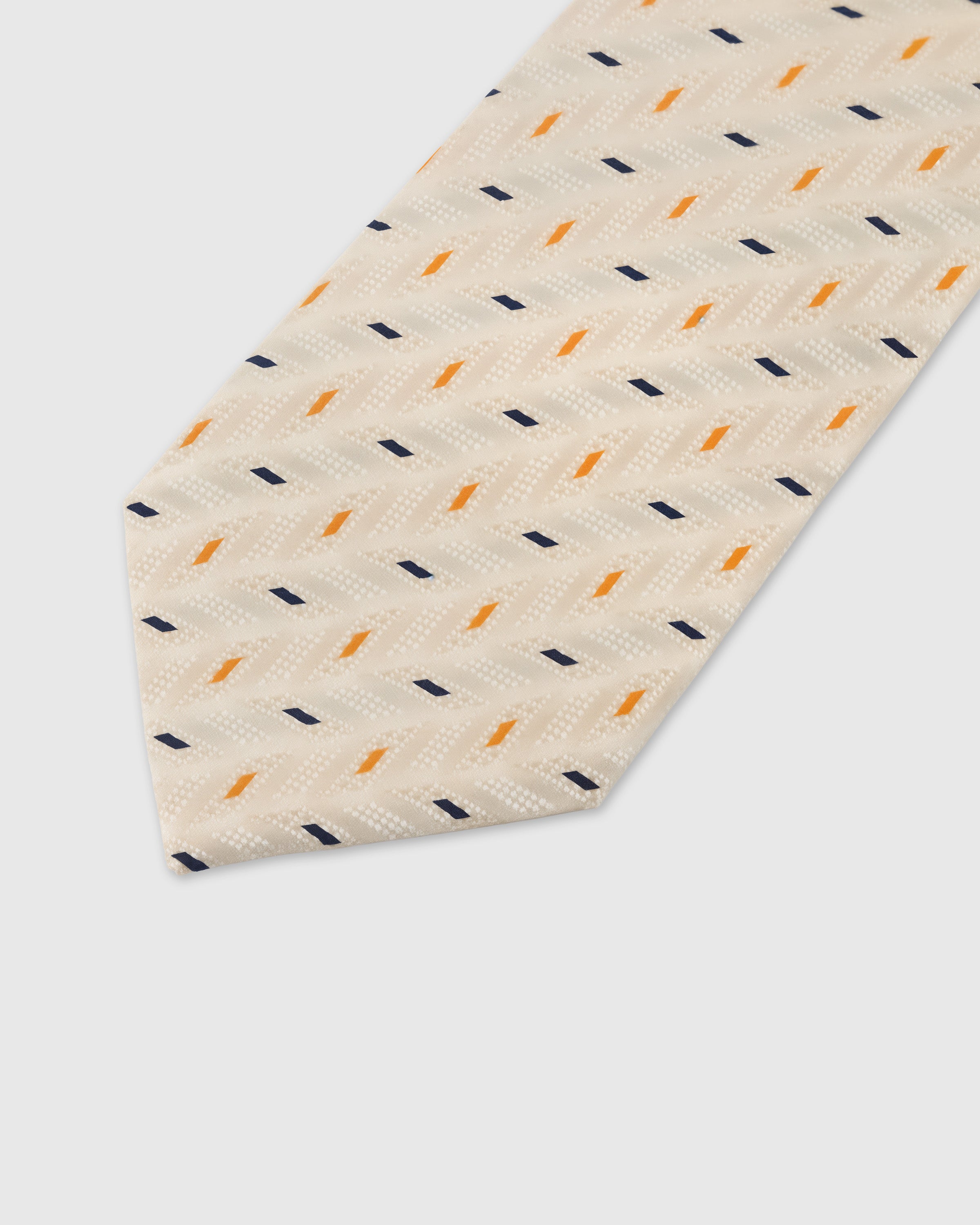 Navy and amber confetti dash detail on pearl mulberry silk tie showing raised hand-embroidered motifs by STICKYZOO