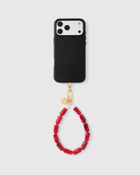 Full phone with ruby marble bead strap attached on light grey background