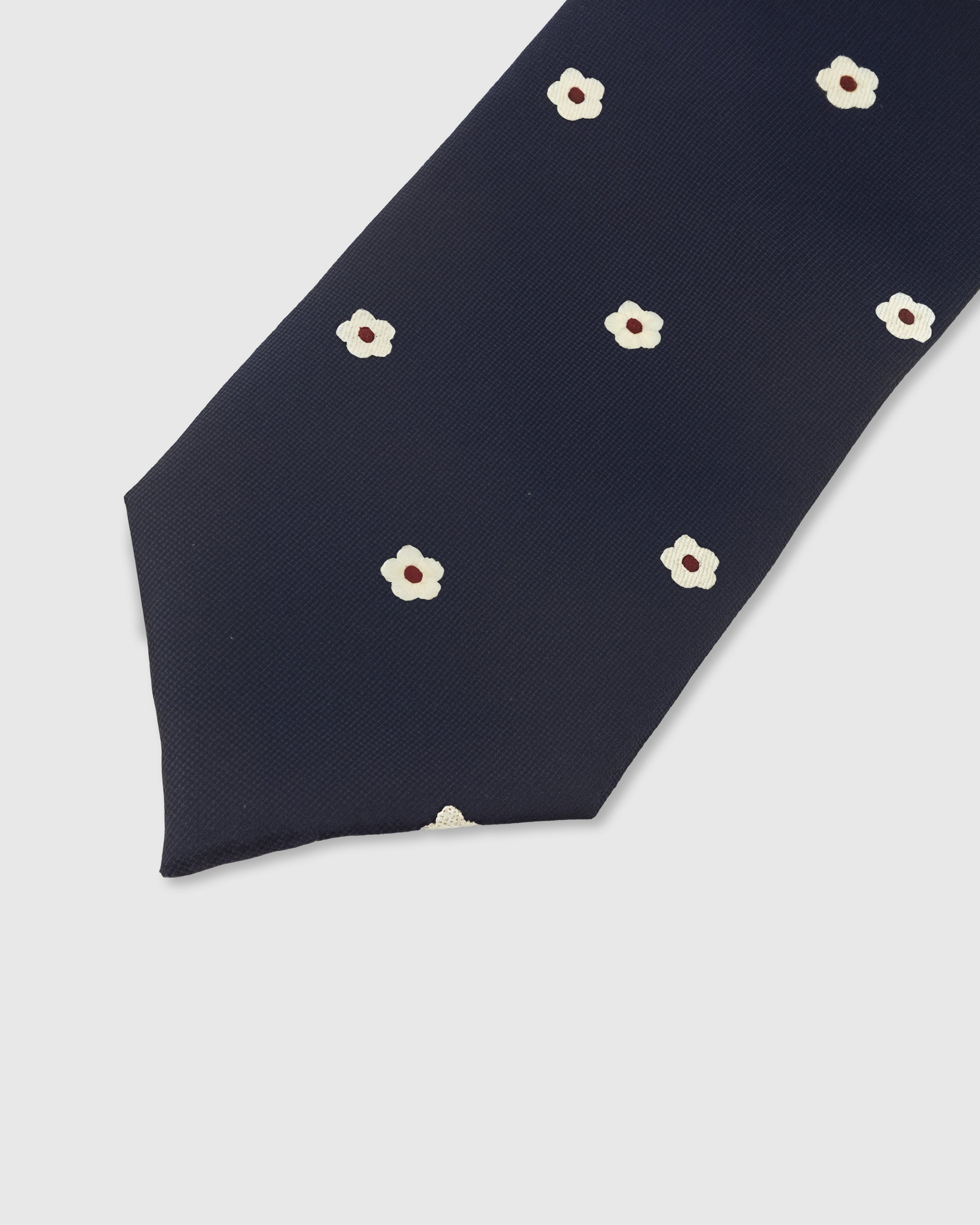 MIDNIGHT BLOSSOM TIE — 45° Italian bias-cut construction with structured interlining, hand-finished slip stitching visible on interior