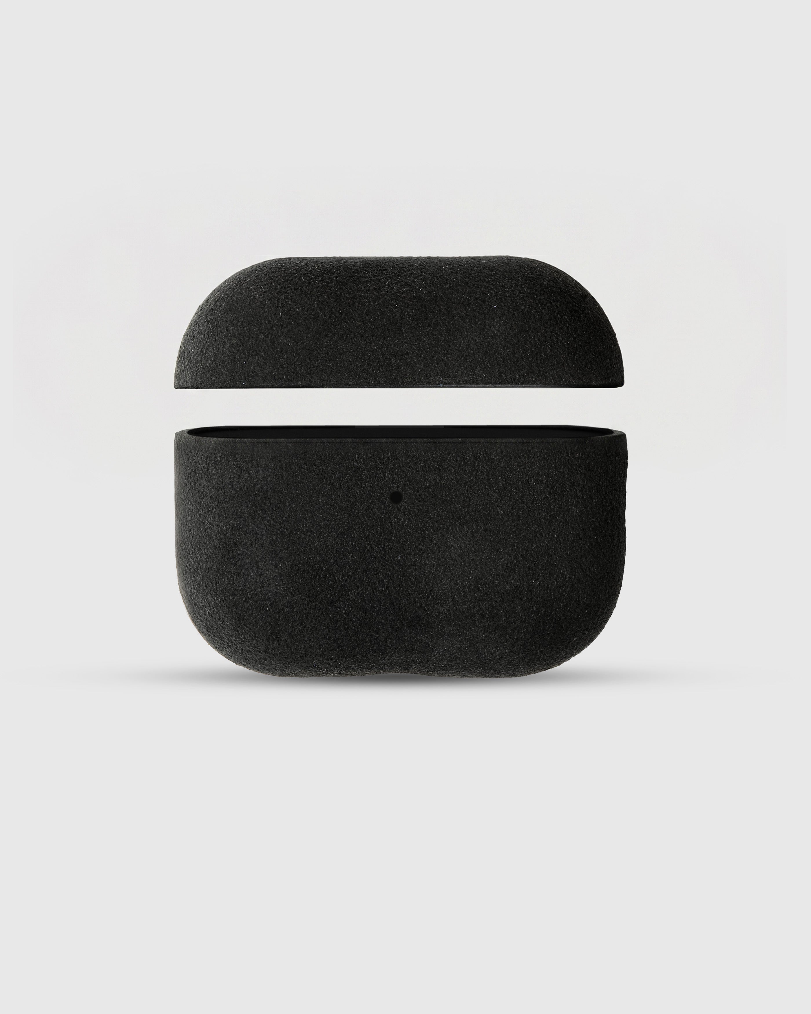 {{AirPods Pro fit securely.}} Black Alcantara case open with AirPods Pro seated inside