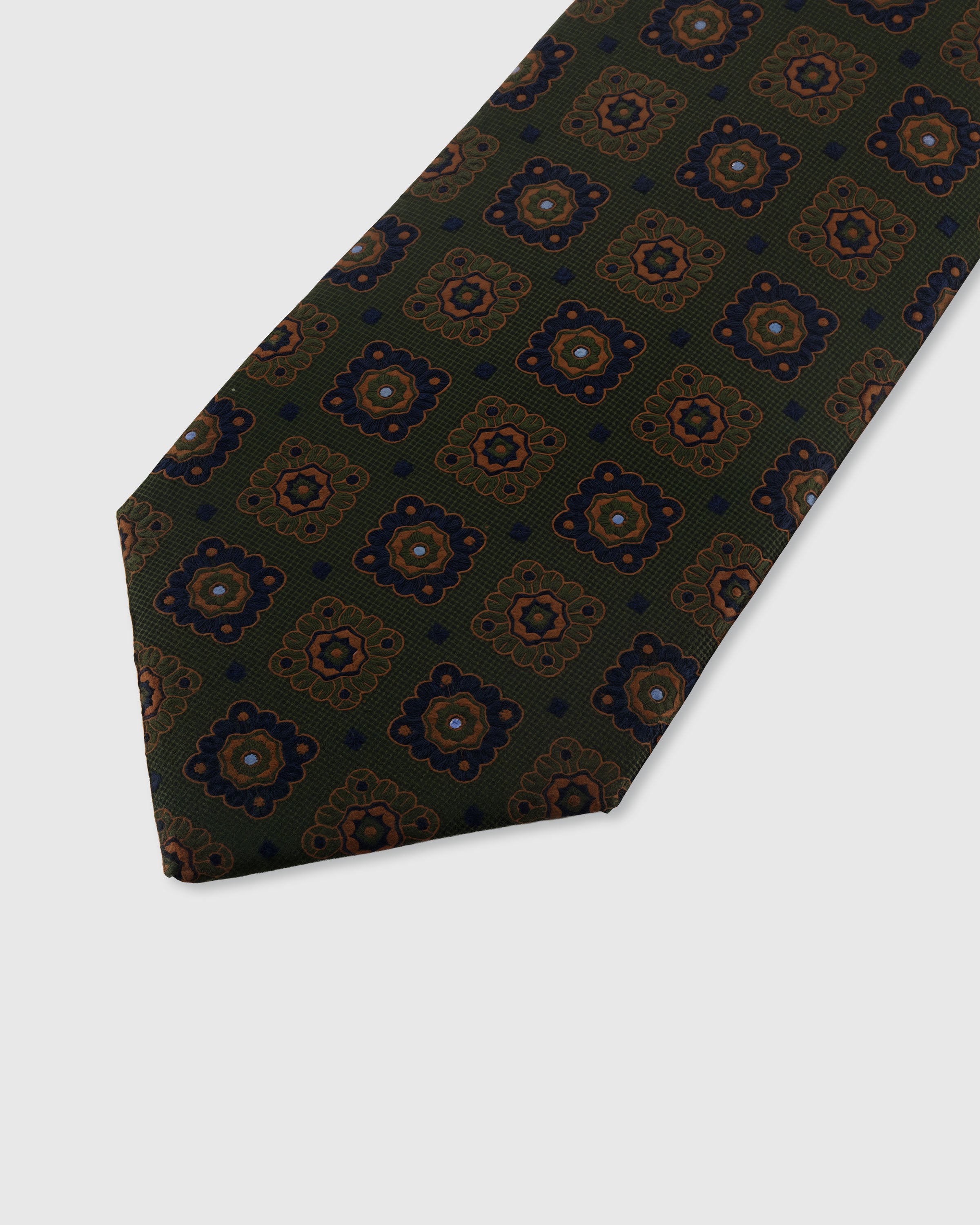STICKYZOO OLIVE MOSAIC TIE — hand-embroidered detail showing ornate medallion motifs in copper, navy, and gold, stitched not printed