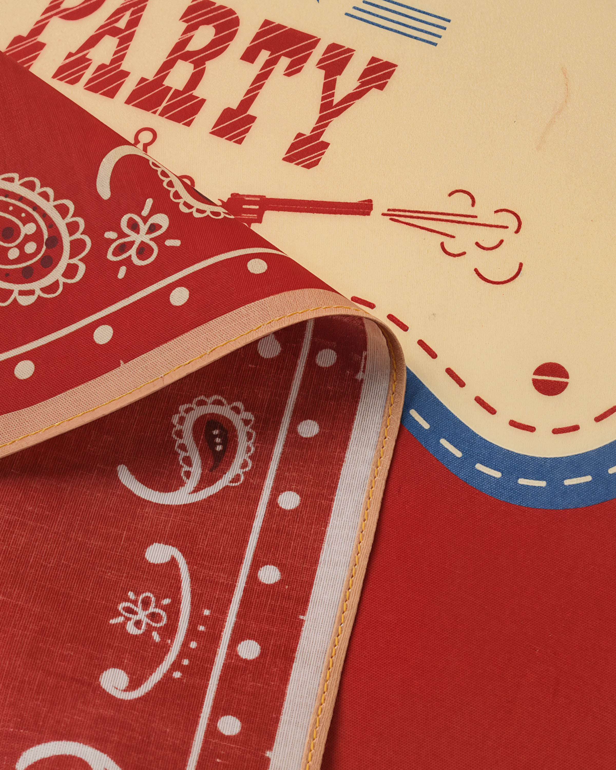 Detail of the printed rodeo placard with boots and bunting on the STICKYZOO rodeo paisley silk scarf
