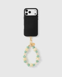 Full phone with butter jade mix strap attached on light grey background