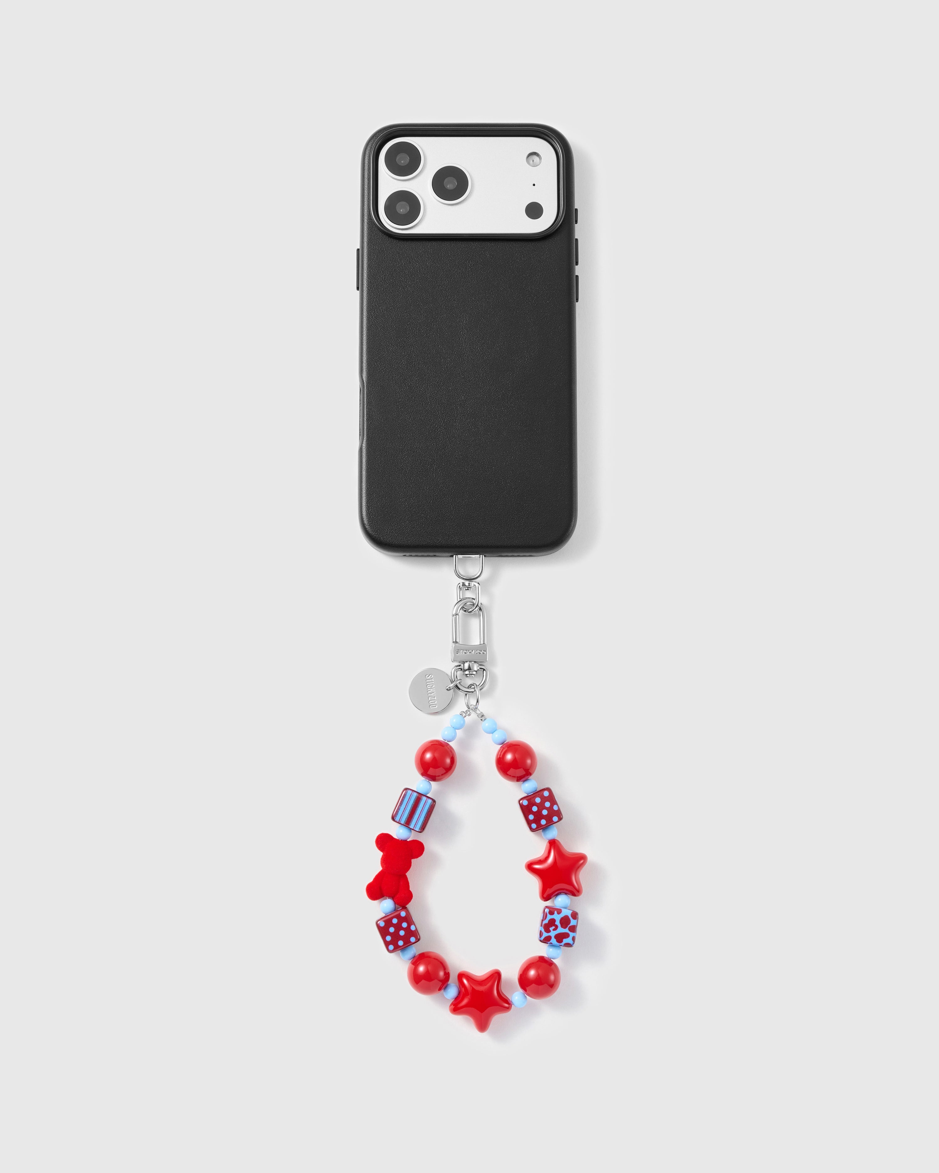 Close-up of red bear, stars, and pattern cube beads showing hand-strung detail with sky-blue spacers