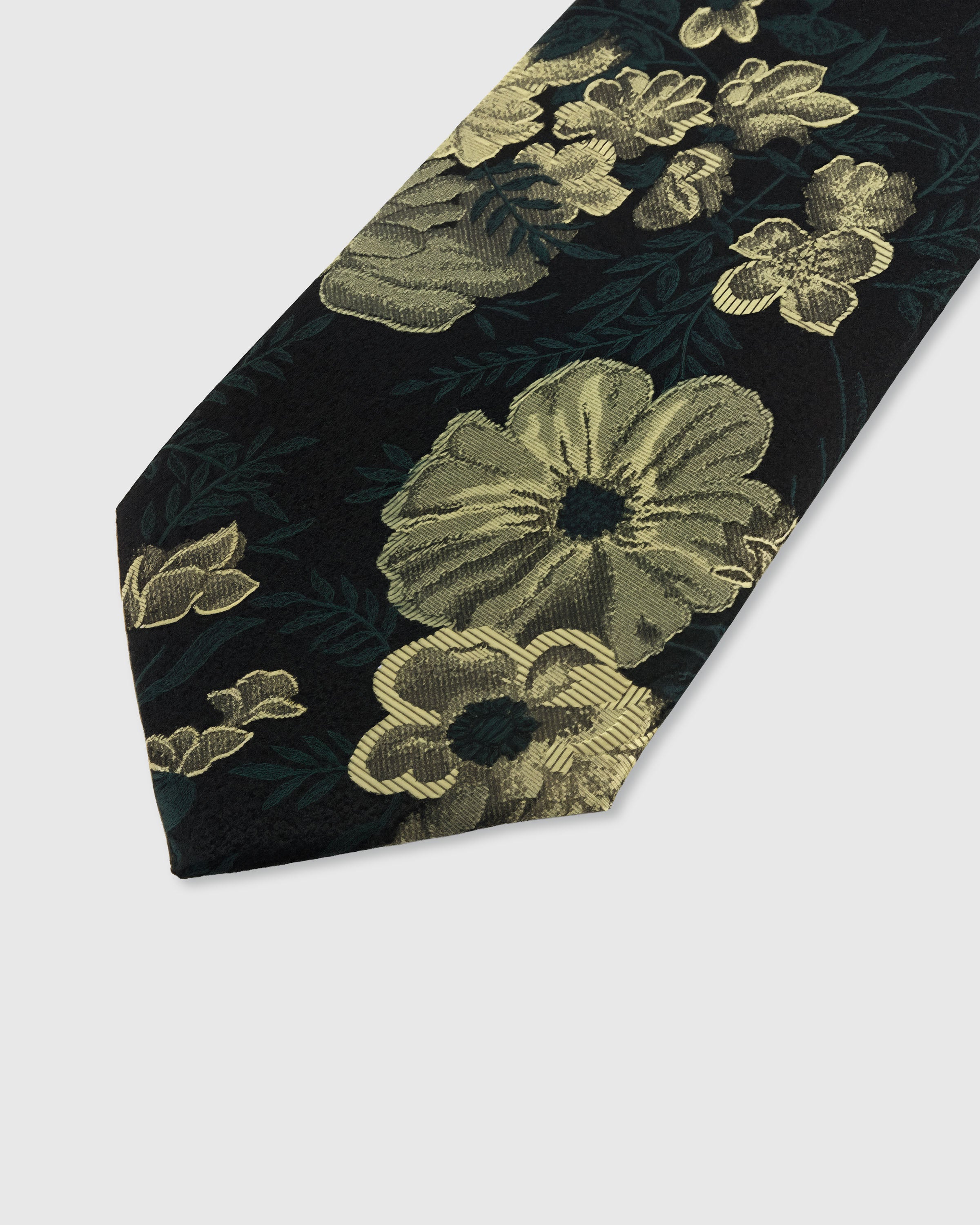 STICKYZOO NOIR BOTANICAL TIE — hand-embroidered detail showing gold-toned botanical blooms and foliage, stitched not printed