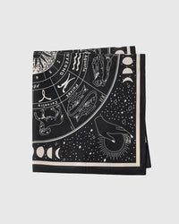 Folded zodiac silk scarf showing the printed signs and the ivory inner frame on midnight silk