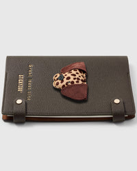 Dalmatian face charm detail showing spotted leather pattern and brown ears on STICKYZOO A5 notebook