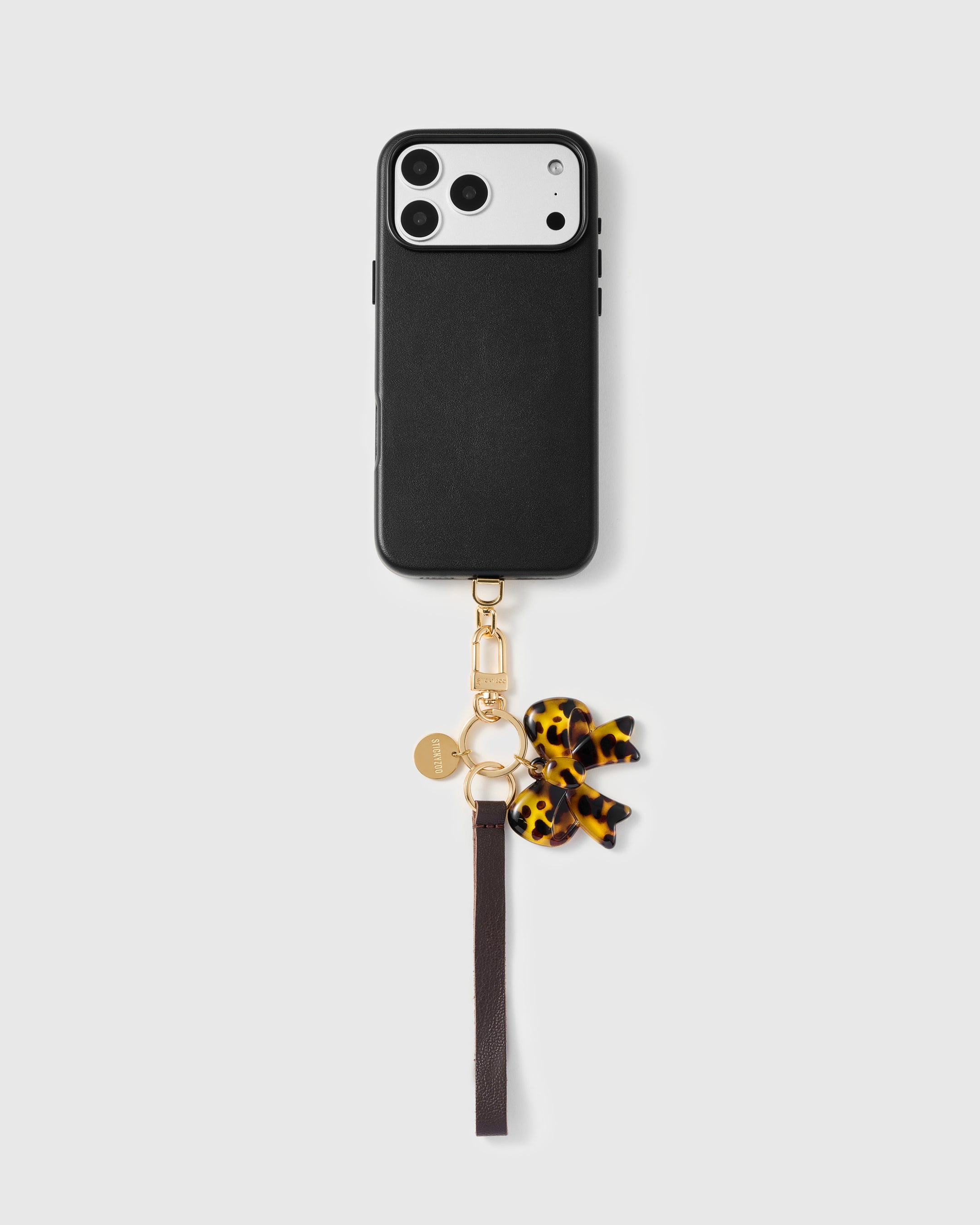 Close-up of tortoise acetate bow showing layered amber and brown pattern with hand-cut edges