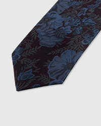 STICKYZOO PLUM PEONY TIE — hand-embroidered detail showing steel-blue peony blooms and delicate foliage, stitched not printed
