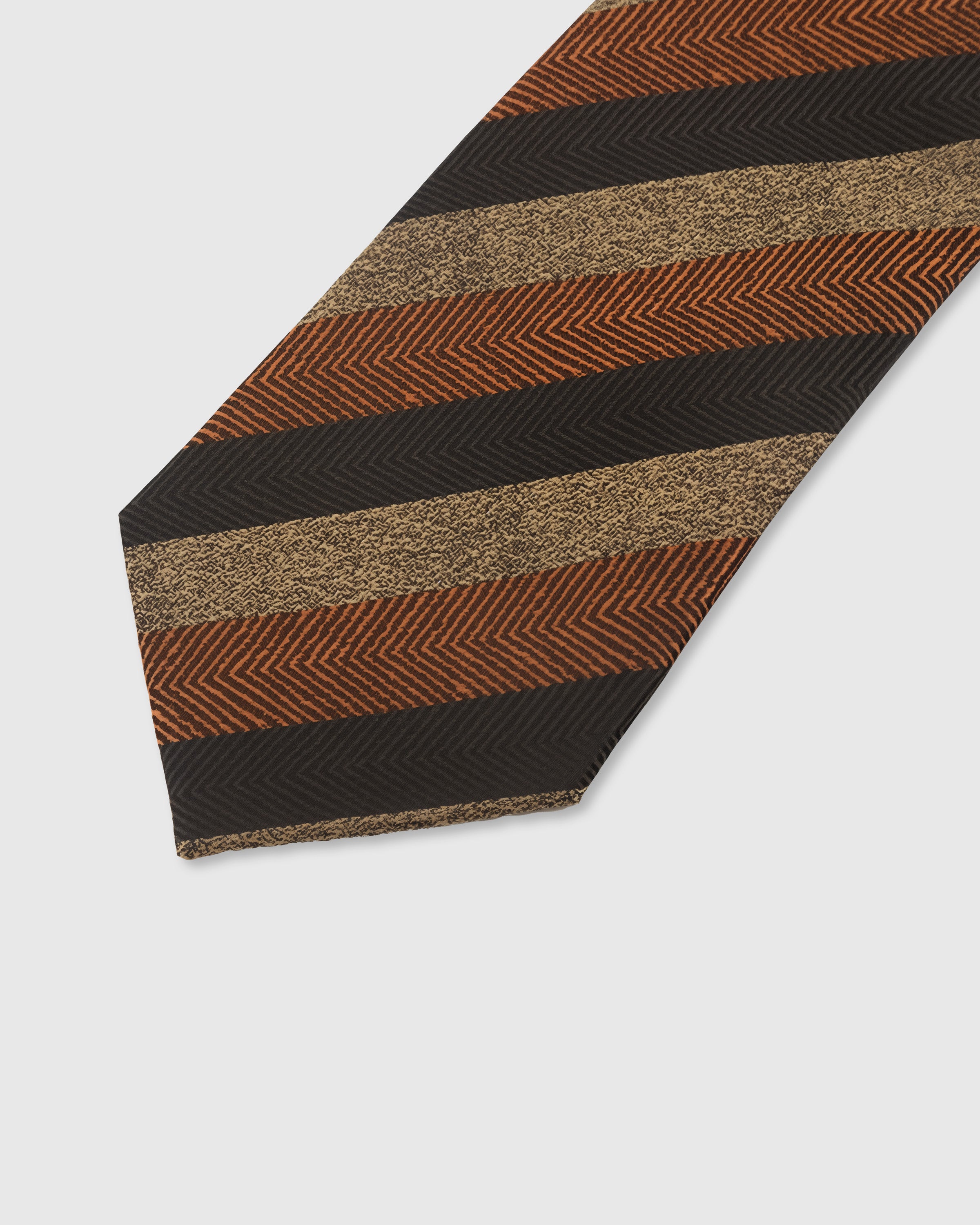 ESPRESSO HERRINGBONE TIE — 45° Italian bias-cut construction with structured interlining, hand-finished slip stitching visible on interior