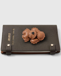 Layered leather poodle teddy charm detail showing hand-stitched scalloped edges and 3D texture on STICKYZOO A5 refillable notebook