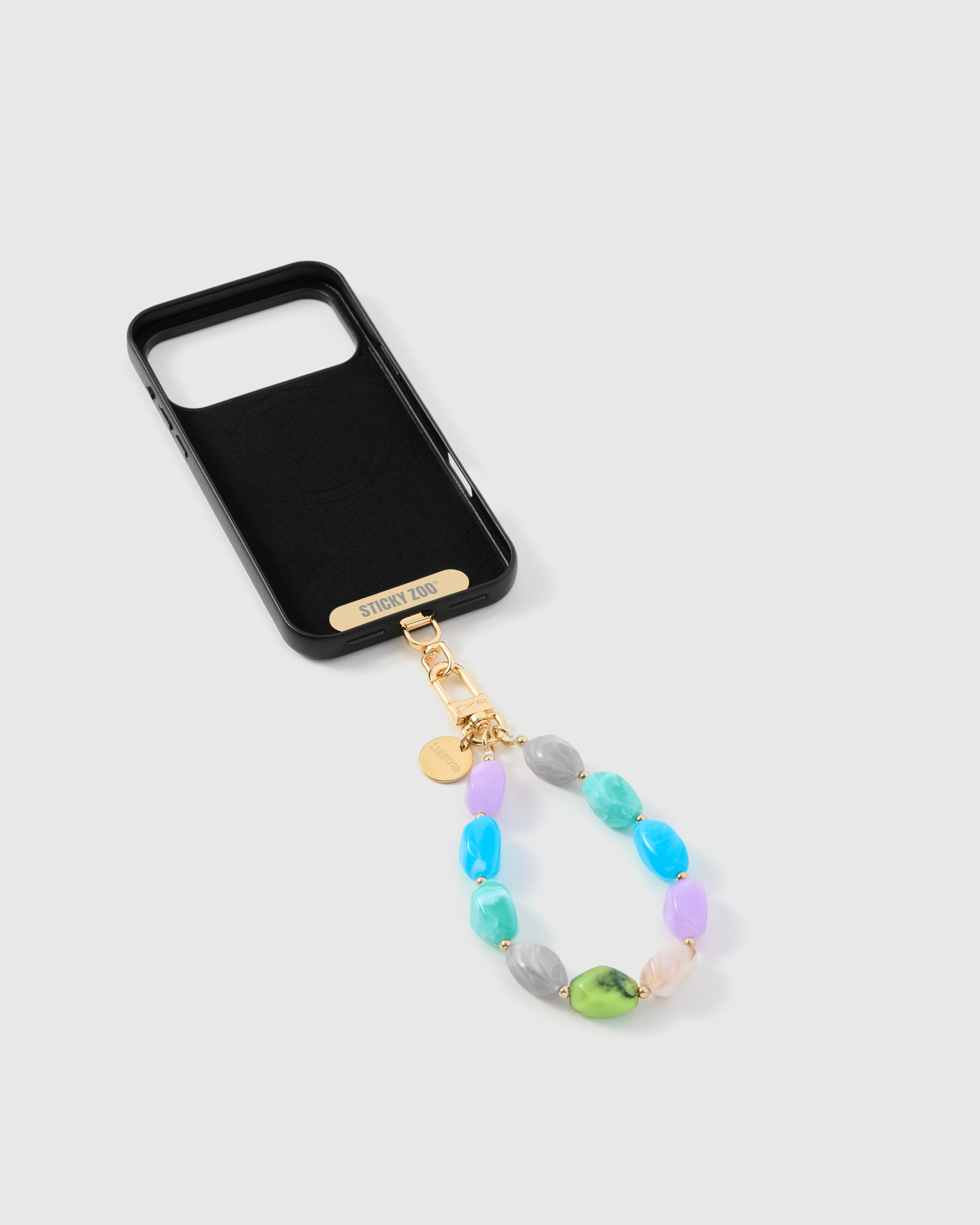 Close-up of glossy pastel marble-swirl beads and gold-tone engraved hardware