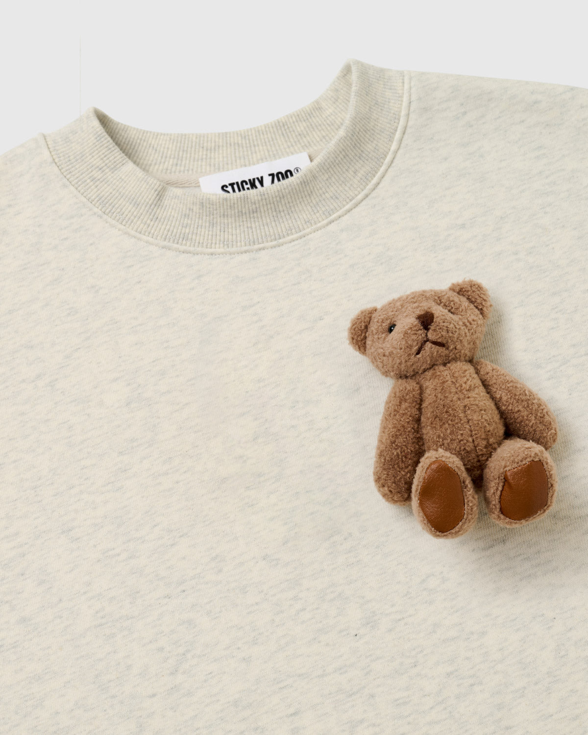 {{Rated 4.9 by thousands}} Close-up of single plush teddy bear on light gray fleece showing embroidered features