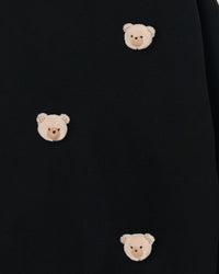 Close-up of multiple plush bear faces showing checkered fabric ears and dimensional stuffed texture