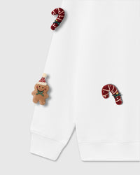 Angled view of plush gingerbread man with Santa hat and candy cane on white 450gsm cotton fleece