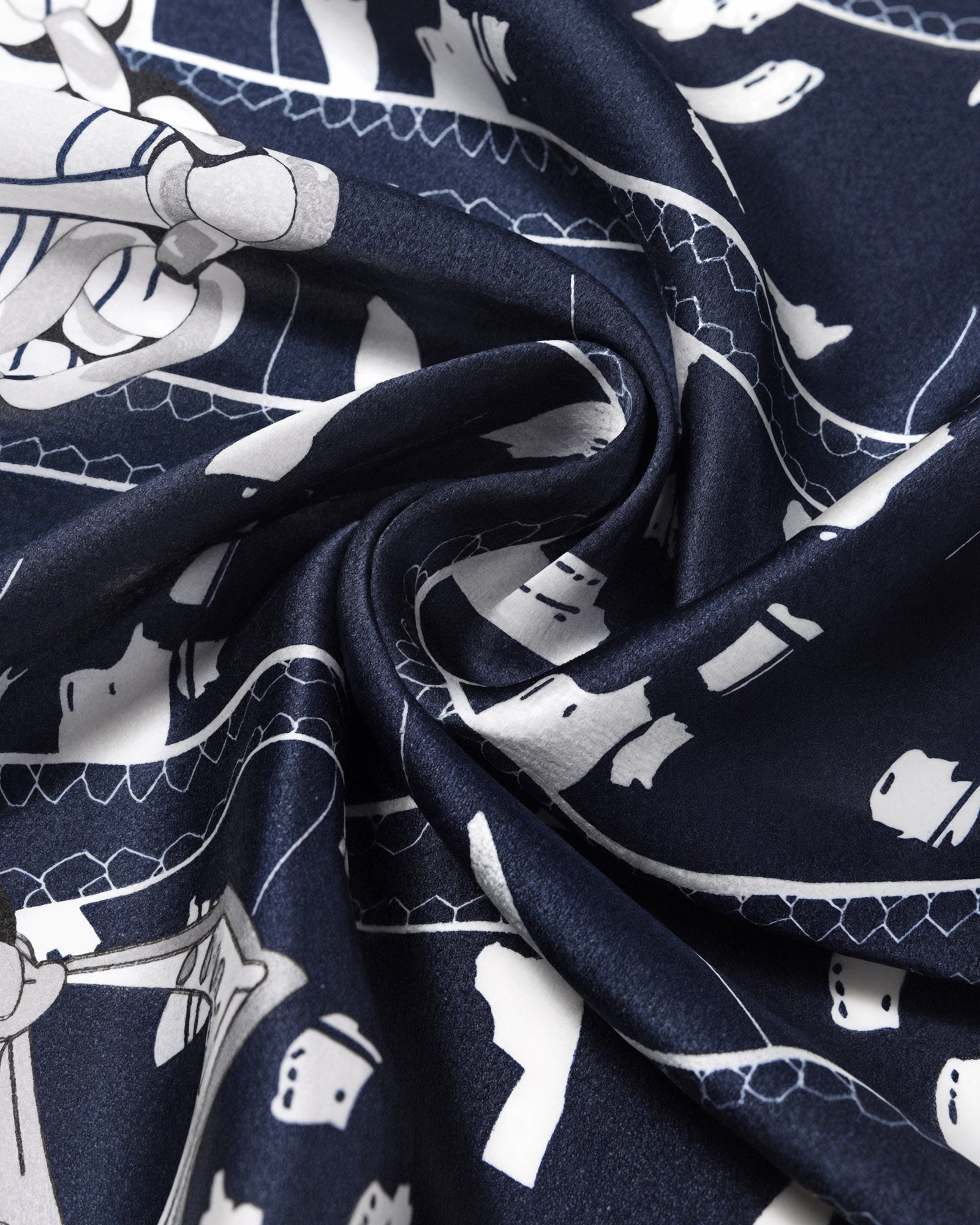 Close-up of the navy silk swirled to show the ivory line-work and the soft silk drape
```