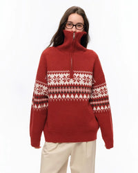 Model wearing STICKYZOO Holiday Sweater in red showing jacquard knit Fair Isle pattern and quarter-zip mock neck