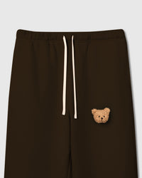 Close-up of plush bear face on dark brown cotton showing tonal depth and sherpa texture