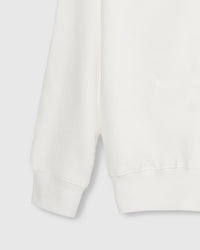 Close-up of ribbed cuff and hem on STICKYZOO white Teddy Bear Sweatshirt showing premium construction