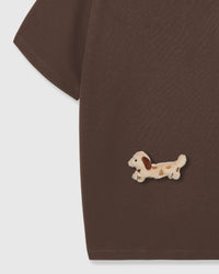 Detail of hand-stitched dachshund applique on brown 230gsm cotton showing floppy ears
