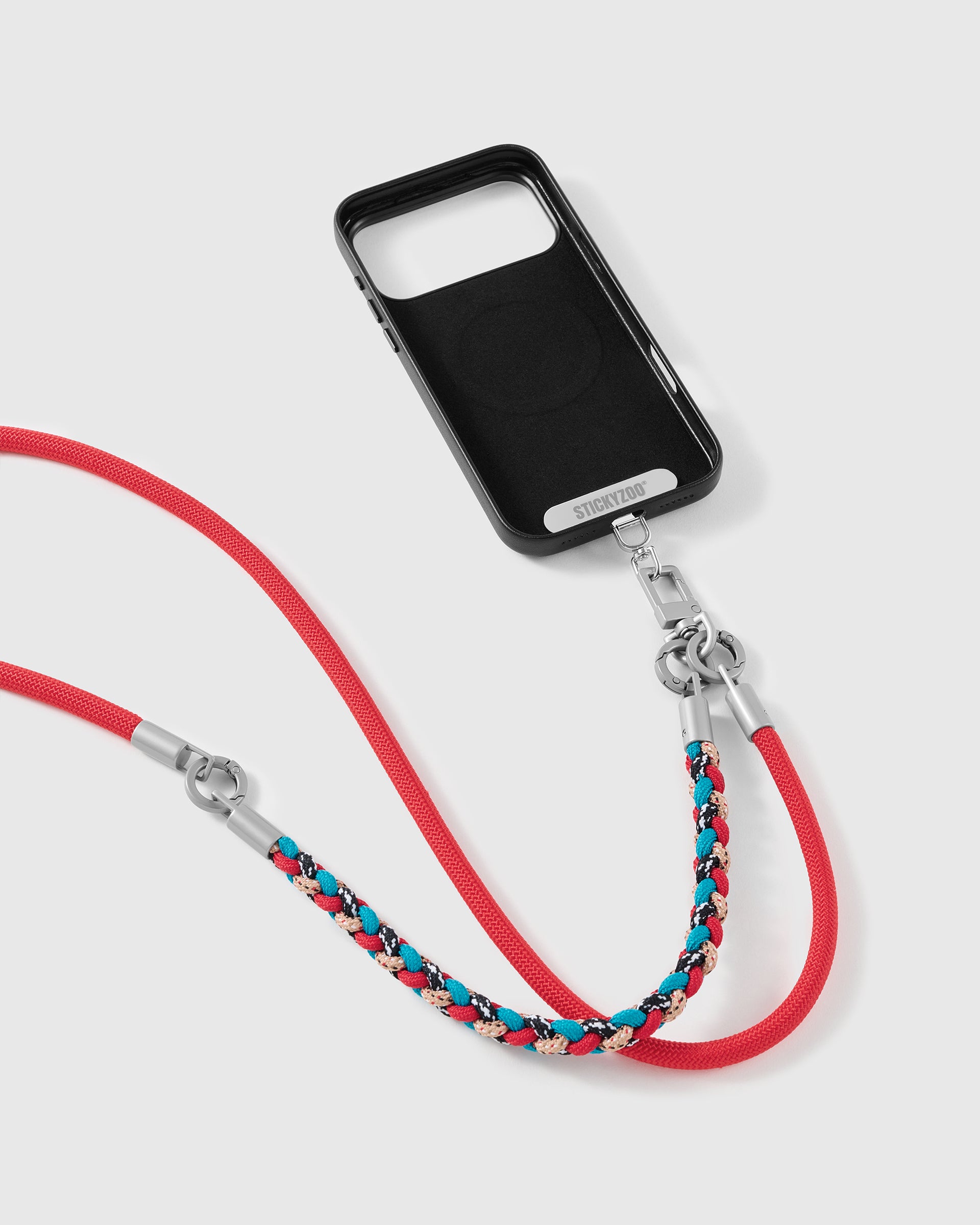 Scarlet strap clipped to a black phone case for hands-free carry