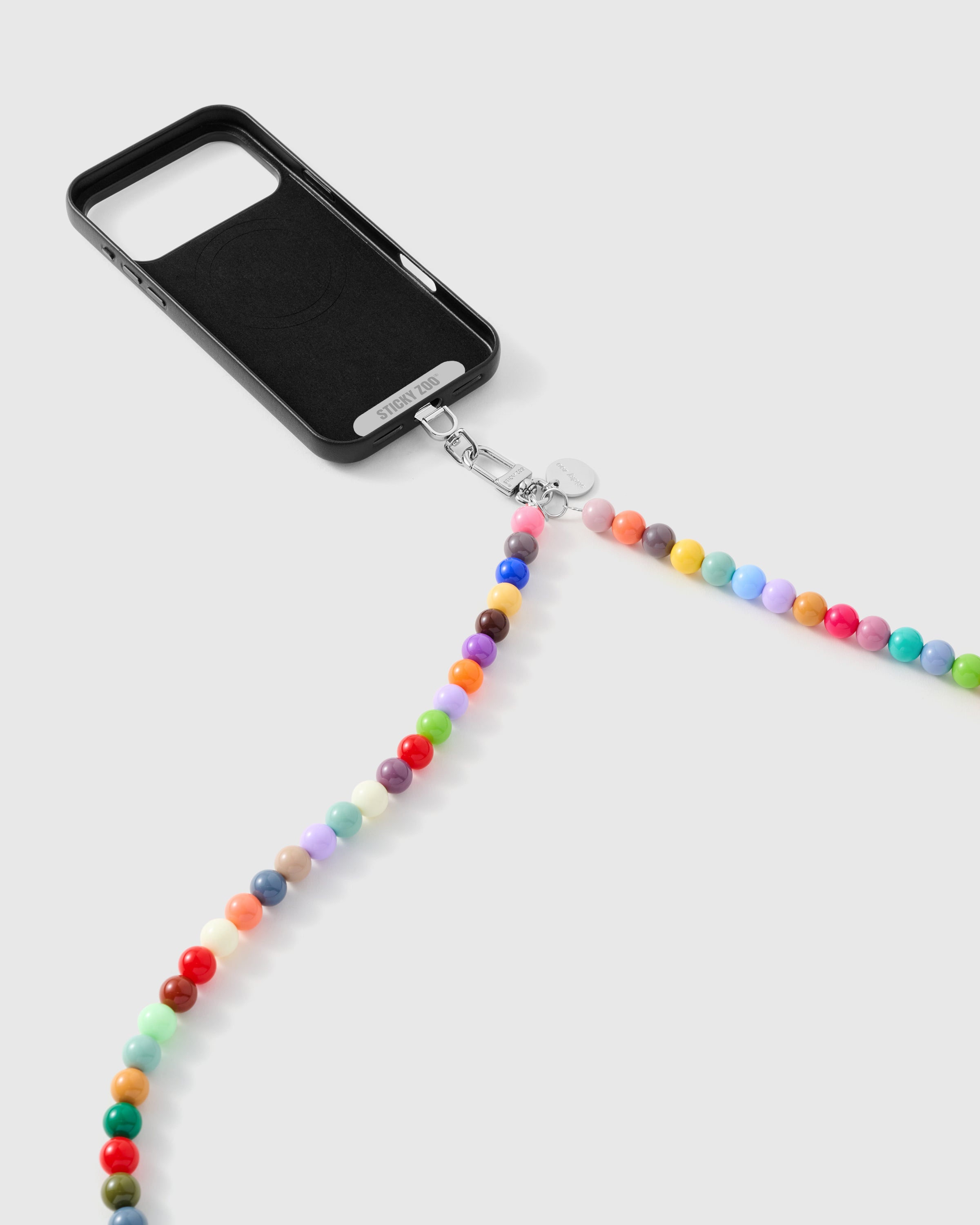 Rainbow beaded phone strap clipping to a phone case with the included Phone Strap Card for a universal fit. Backed by 5,000+ reviews.