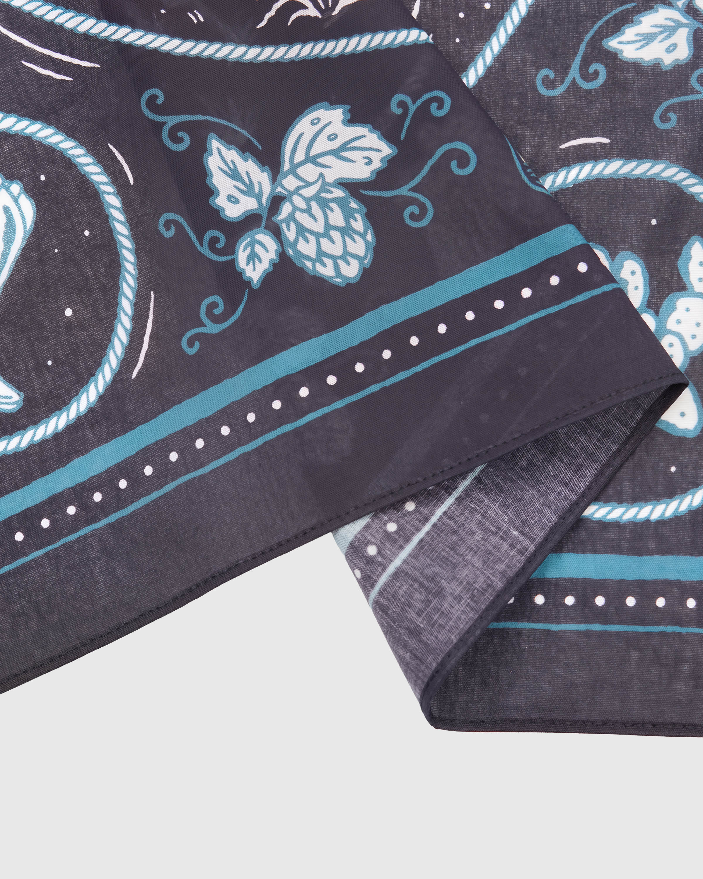 STICKYZOO campfire critters silk scarf showing the printed hop-vine border and stitched hem detail