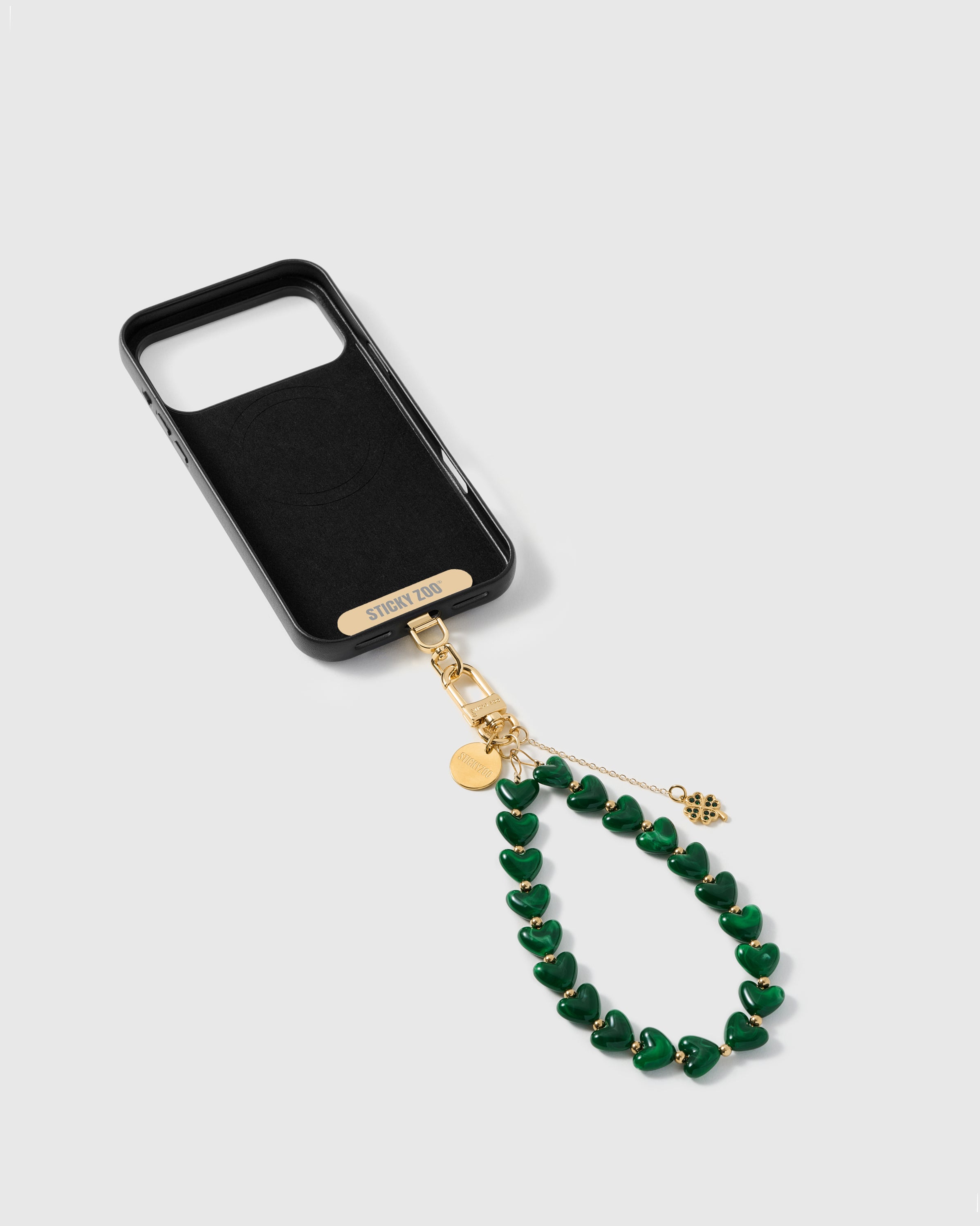 PHONE STRAP CARD INCLUDED — Inside of phone case showing STICKYZOO Phone Strap Card with gold hardware