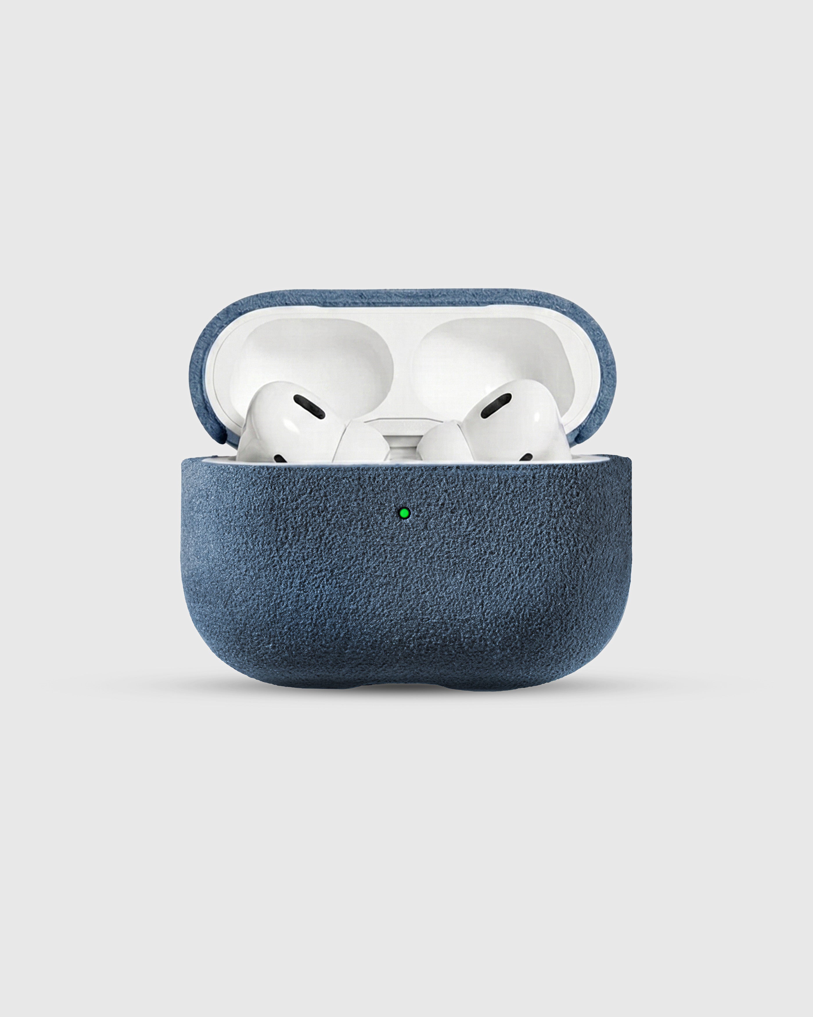 {{AirPods Pro fit securely.}} Denim Blue Alcantara case open with AirPods Pro seated inside