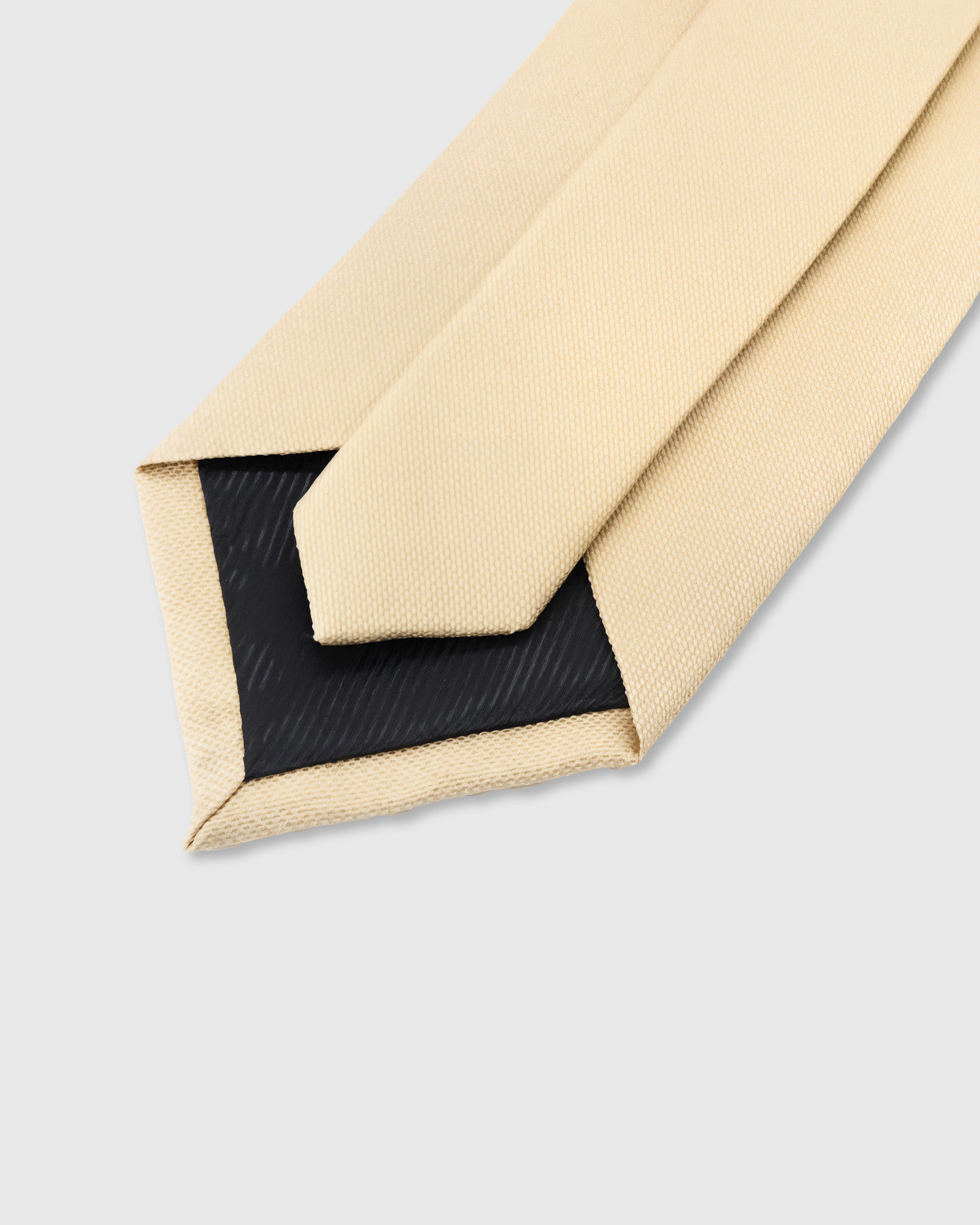 STICKYZOO Champagne Solid Tie interior detail showing structured interlining and hand-finished slip stitching, 145 × 8 cm
